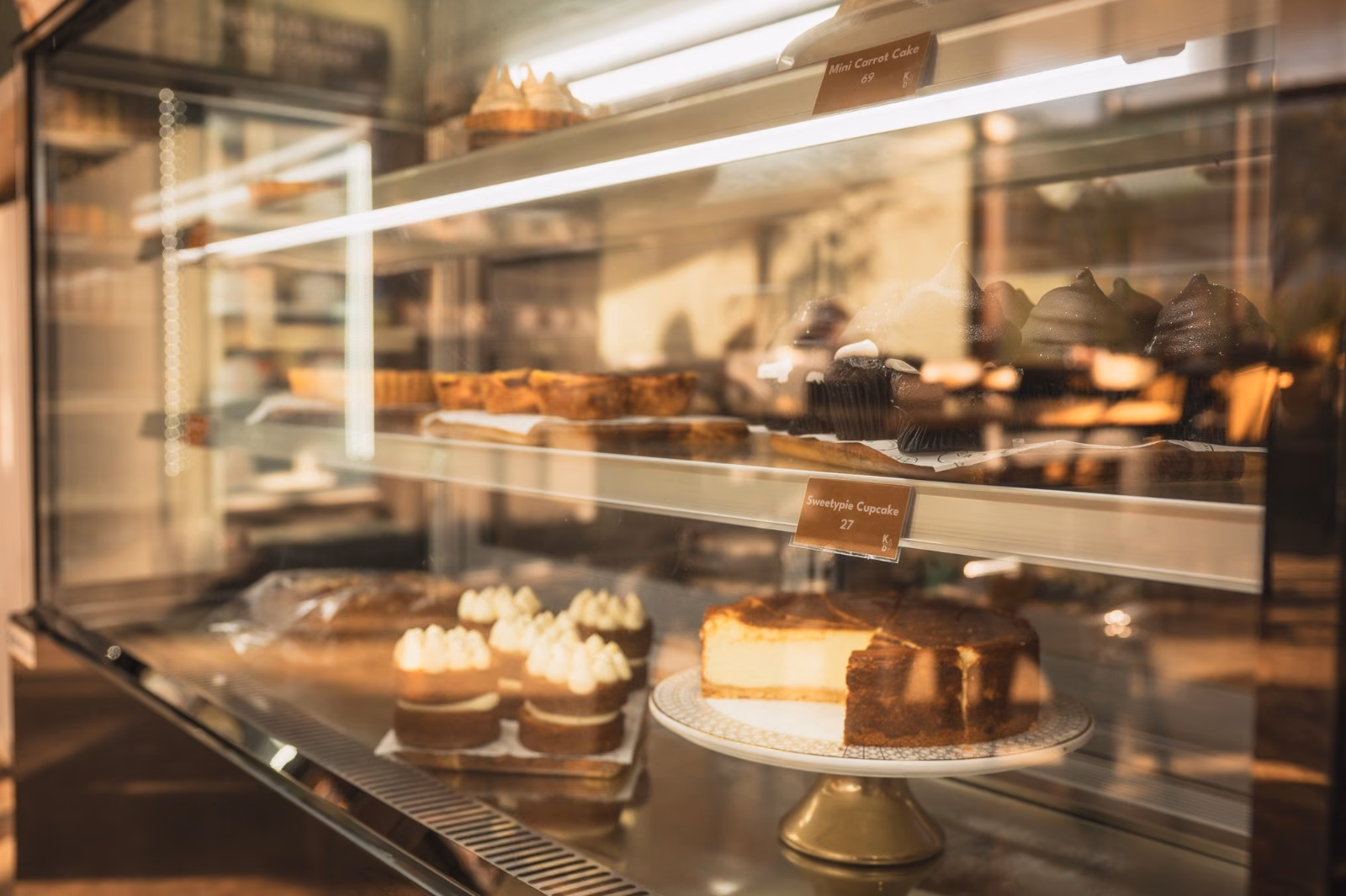 Kole & Deeg — the bakery counter display of cheesecake, tarts and pastries