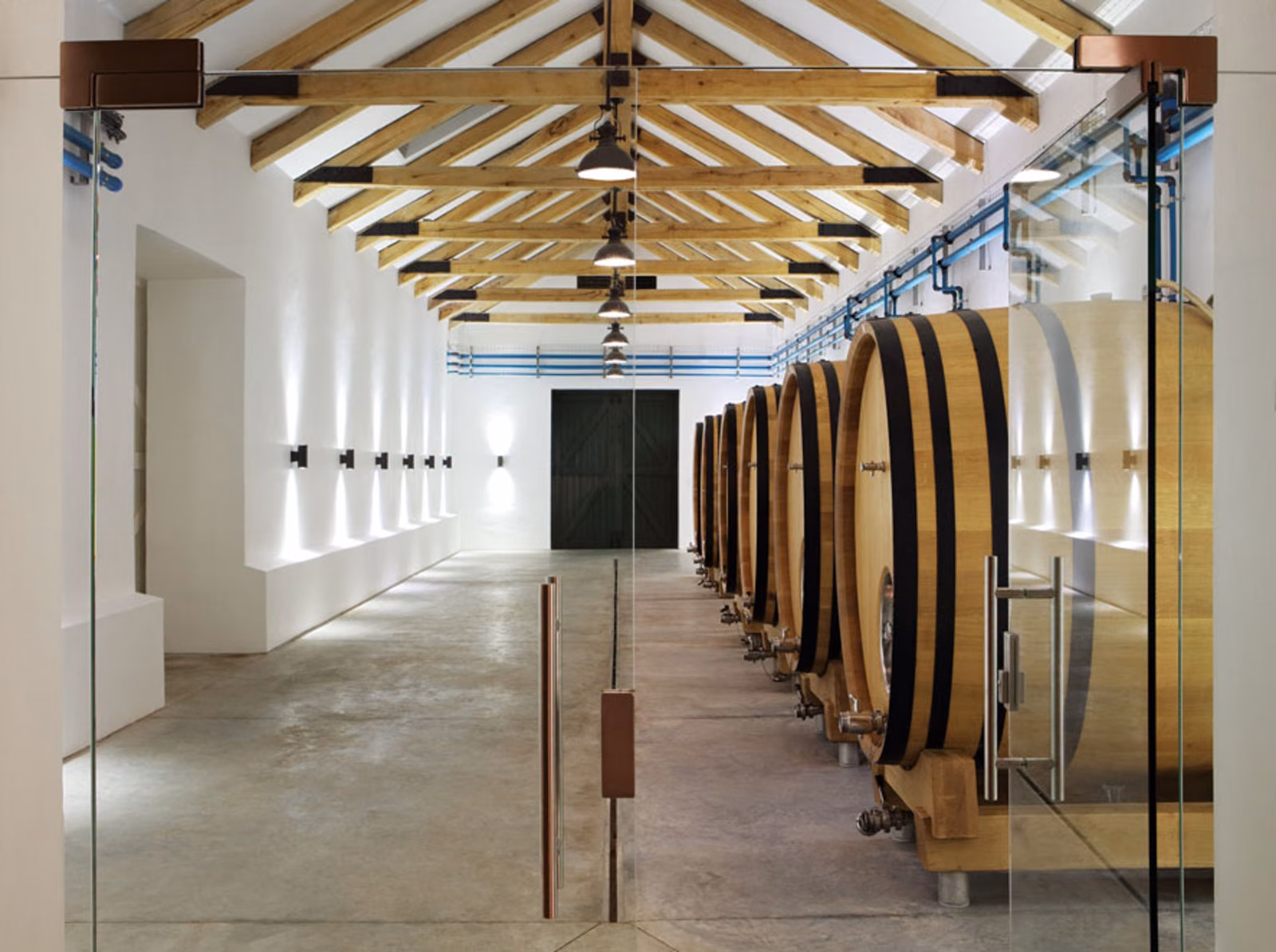 Krone — the barrel cellar, a row of large oak foudres beneath an exposed timber roof