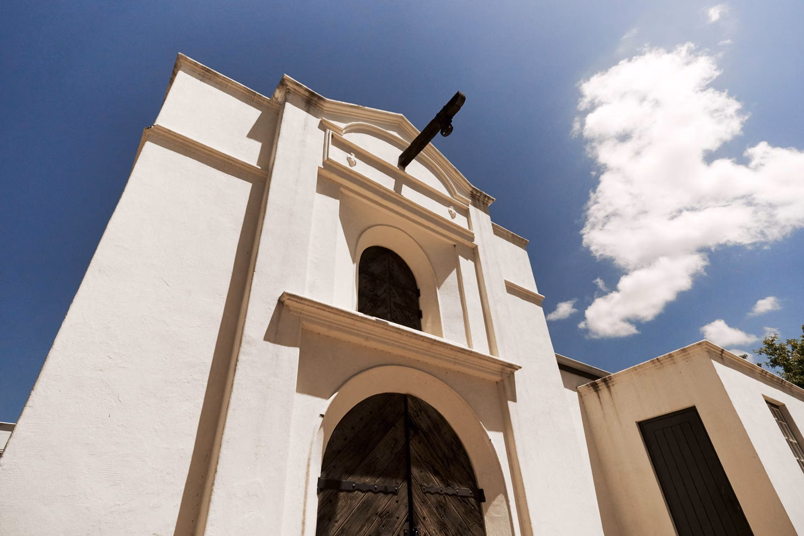 Krone — the white gabled bell tower of the Twee Jonge Gezellen estate against a blue sky
